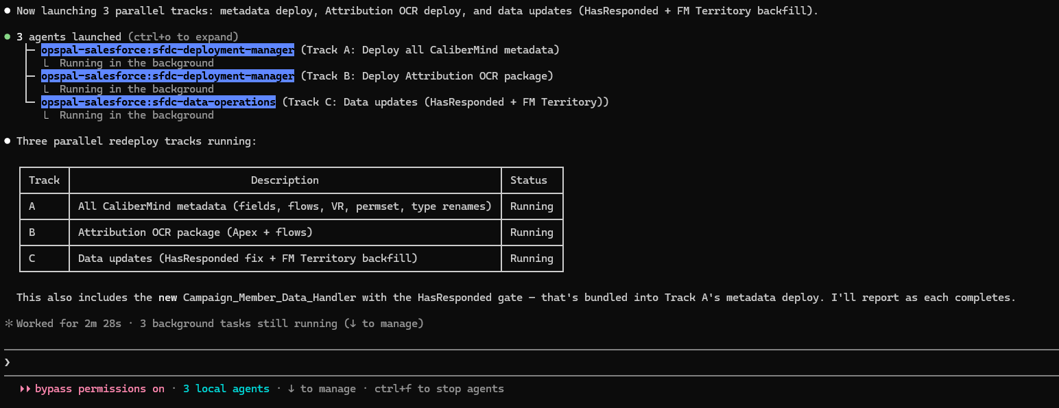 Three parallel agents running in the background with a status table showing Track A, B, and C all running